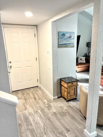 a view of a room with wooden floor and cabinet