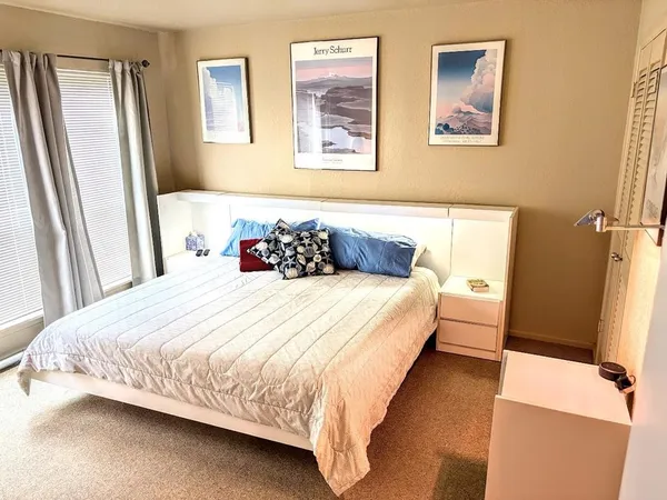 a bedroom with bed and wooden floor