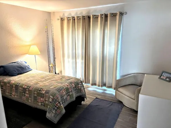 a bedroom with a bed and a window