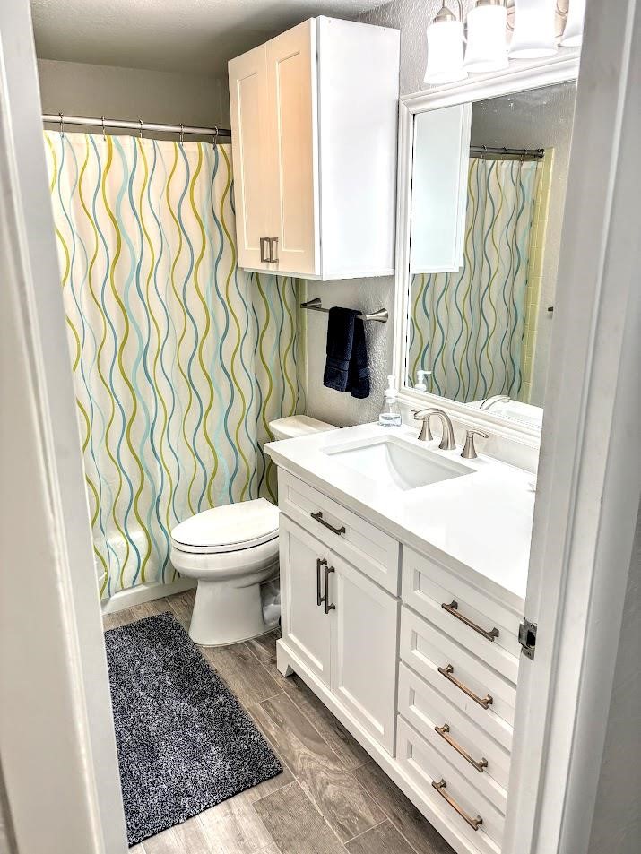 2003 North Fulton Beach Road, Unit 23 Rockport, TX 78382 - Photo 18 of 23 a bathroom with a sink a toilet and a window