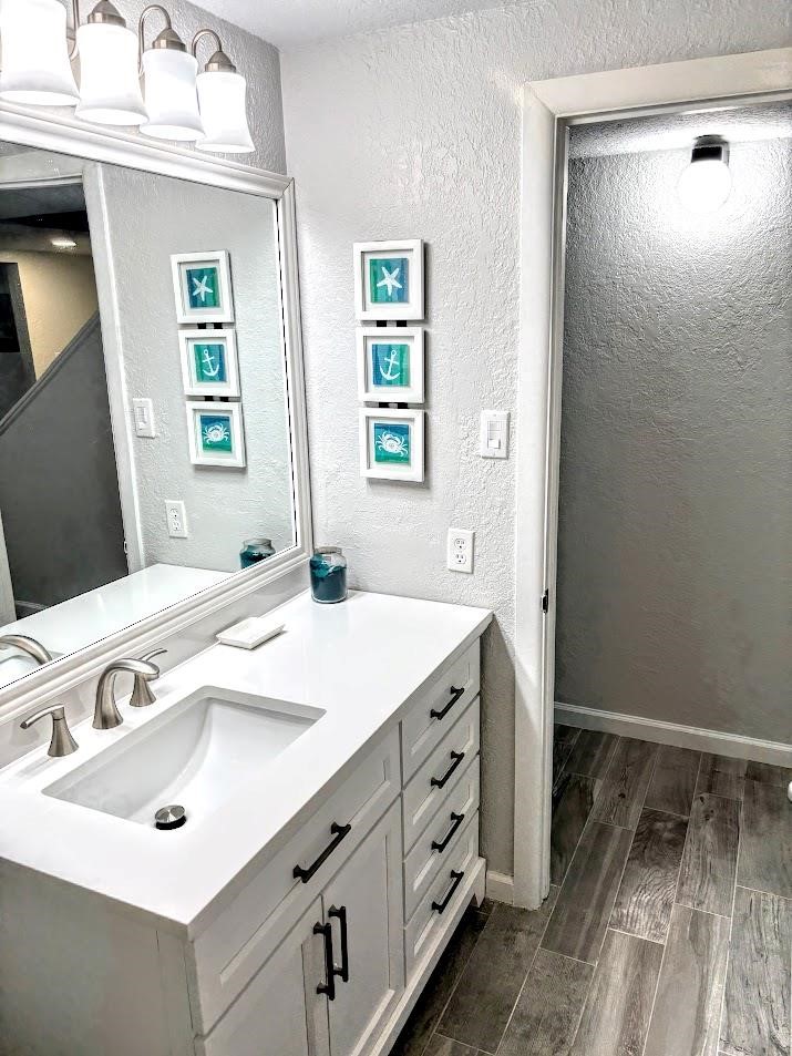 2003 North Fulton Beach Road, Unit 23 Rockport, TX 78382 - Photo 19 of 23 a bathroom with a sink vanity and mirror