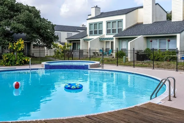 a view of a swimming pool with sitting area