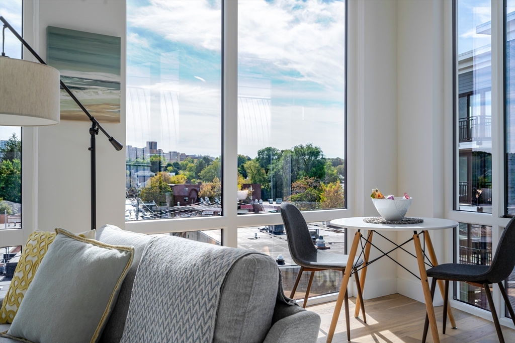 38 Hichborn Street, Unit 401 Boston, MA 02135 - Photo 3 of 11 a living room with furniture and a floor to ceiling window