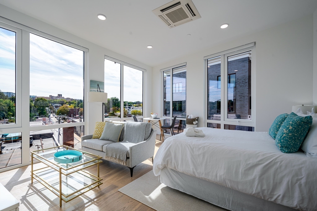 38 Hichborn Street, Unit 401 Boston, MA 02135 - Photo 4 of 11 a spacious bedroom with a large window and a balcony