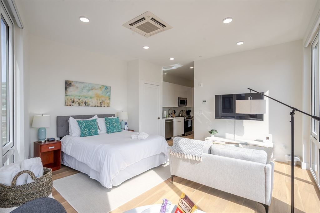 38 Hichborn Street, Unit 401 Boston, MA 02135 - Photo 5 of 11 a bedroom with a bed and furniture