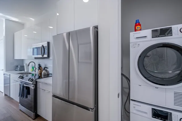 a kitchen with stainless steel appliances granite countertop a refrigerator and a stove