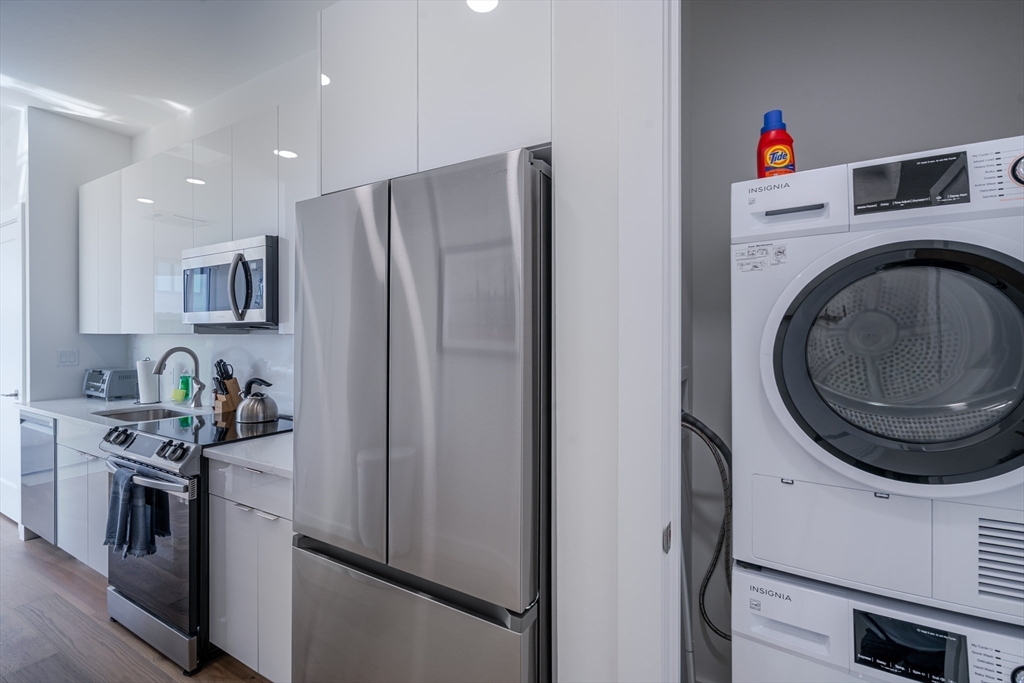 38 Hichborn Street, Unit 401 Boston, MA 02135 - Photo 7 of 11 a kitchen with stainless steel appliances granite countertop a refrigerator and a stove