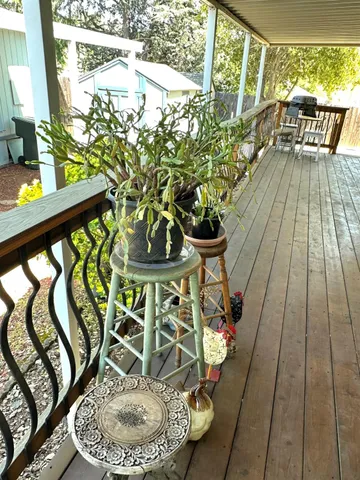 a view of a porch with furniture and garden