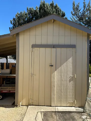 a view of a backyard with plants and trees