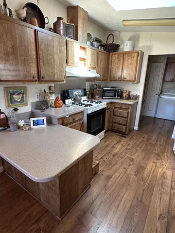 a kitchen with stainless steel appliances a stove a sink dishwasher and a refrigerator
