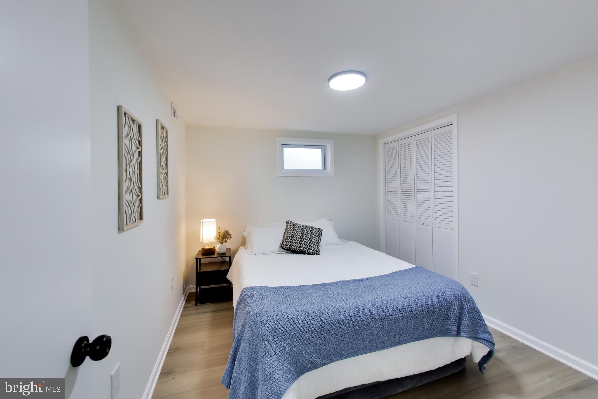 11309 Keystone Avenue Clinton, MD 20735 - Photo 24 of 36 a bedroom with a bed and wooden floor
