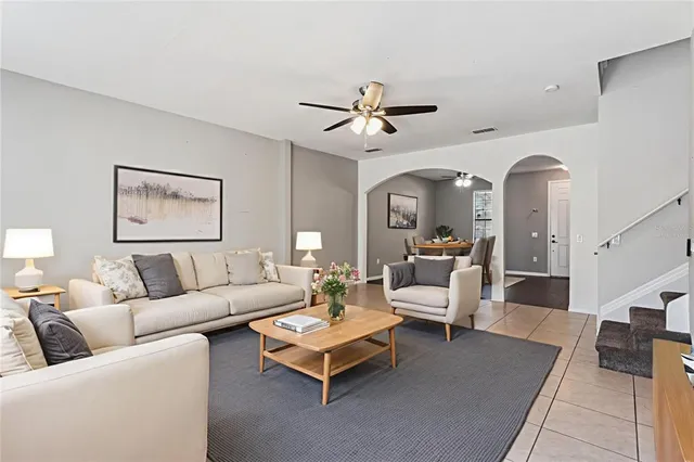 a living room with furniture and a chandelier