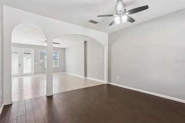 wooden floor in an empty room with a window