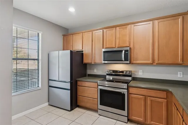 a kitchen with a refrigerator stove and microwave