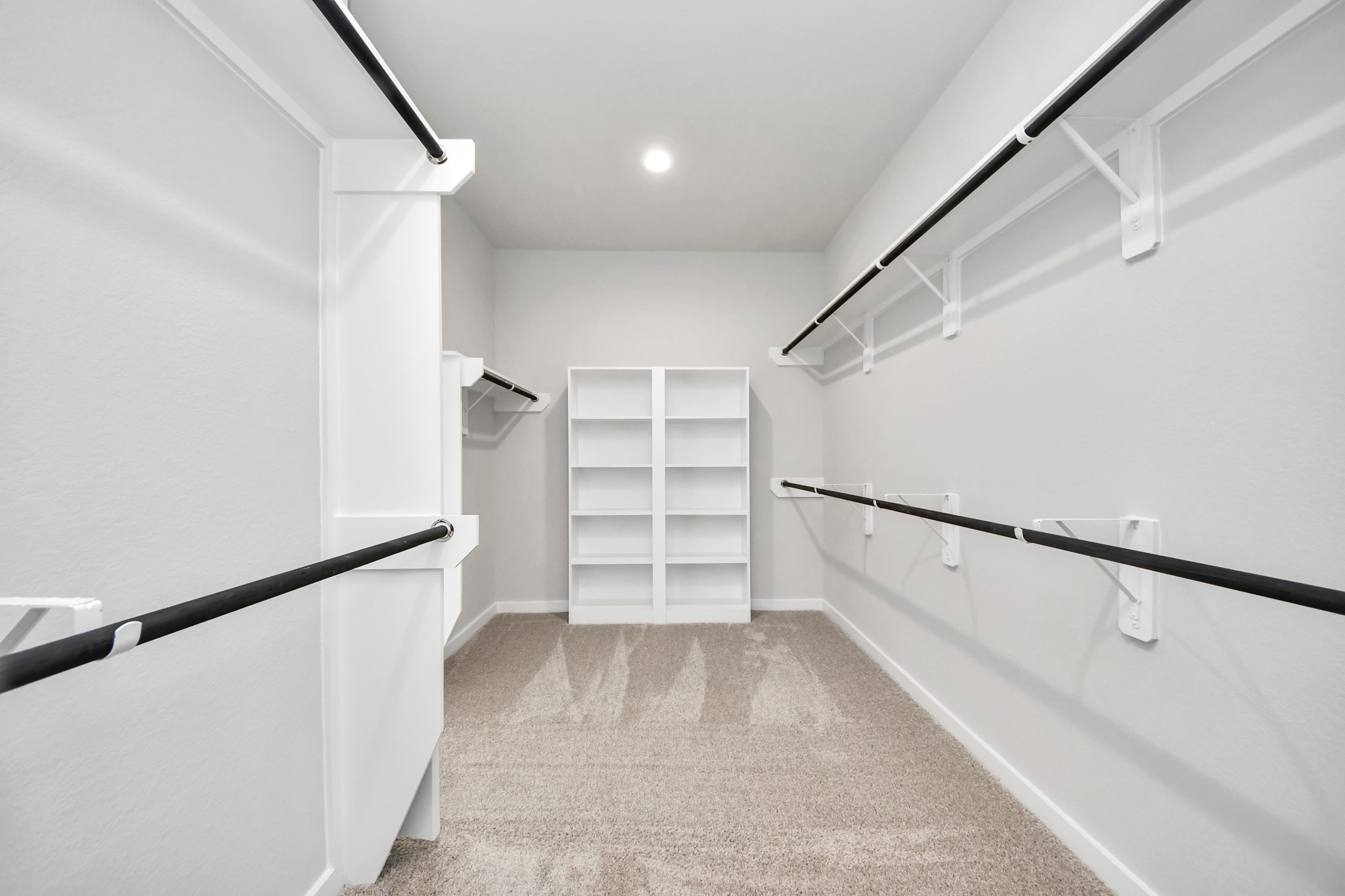 11106 Tulip Rdg Trail Houston, TX 77044 - Photo 23 of 34 Walk-in closet that epitomizes luxury and practicality. This generously sized space features built-in shelving, offering abundant room for impeccable organization. High ceilings and recessed lighting create a bright and welcoming ambiance. Sample photo of completed home with similar floor plan. Actual colors and selections may vary.