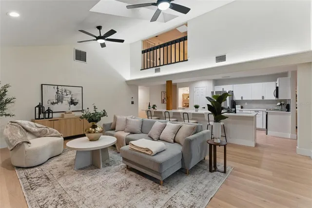 a living room with furniture and view of kitchen