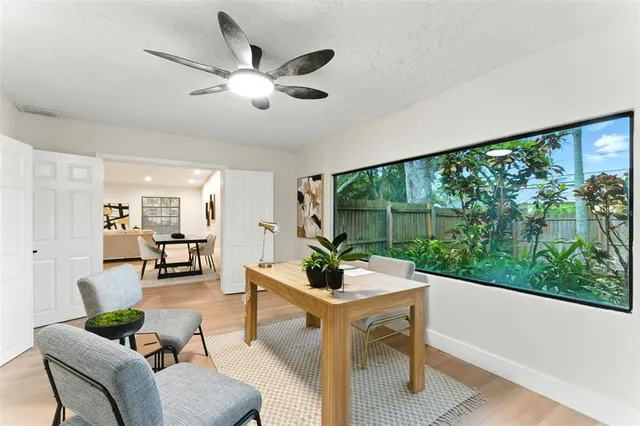a living room with furniture and large windows