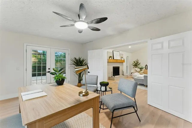 a view of a livingroom with furniture a flat screen tv and a large window