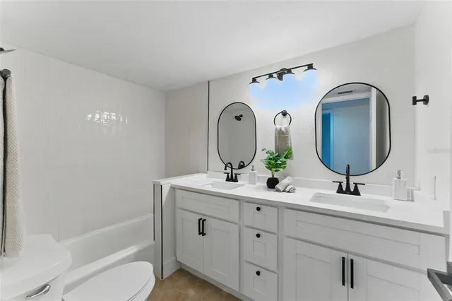 a hallway with painting on the wall and a wooden floor