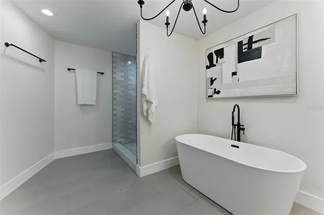 a bathroom with a double vanity sink a toilet a mirror and shower