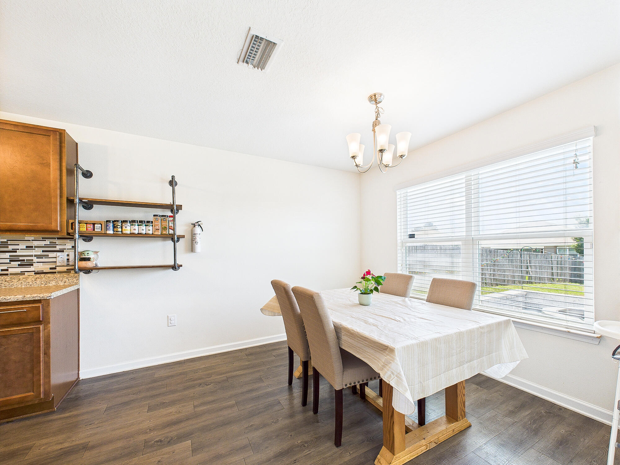 4611 Plover Drive Crestview, FL 32539 - Photo 11 of 27 a view of a dining room with furniture window and wooden floor