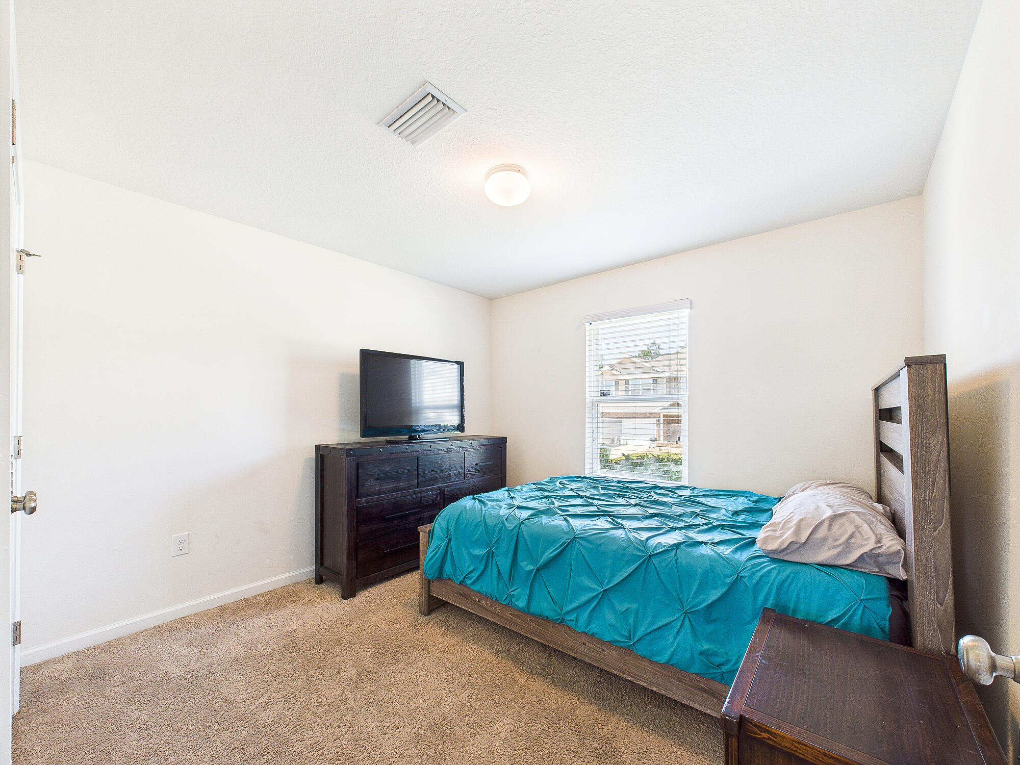 4611 Plover Drive Crestview, FL 32539 - Photo 17 of 27 a bedroom with a bed and a television