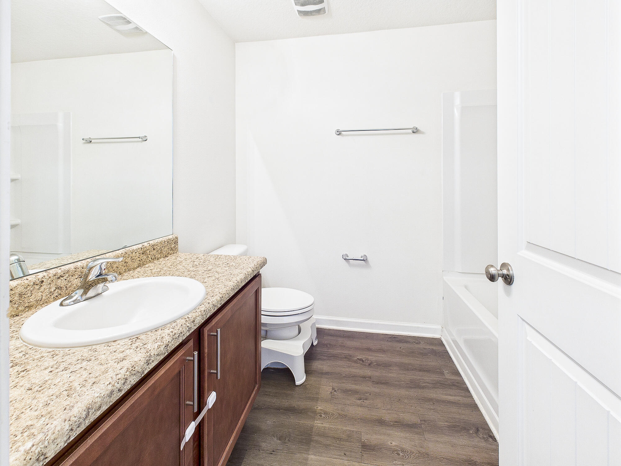 4611 Plover Drive Crestview, FL 32539 - Photo 19 of 27 a bathroom with a granite countertop sink and a mirror