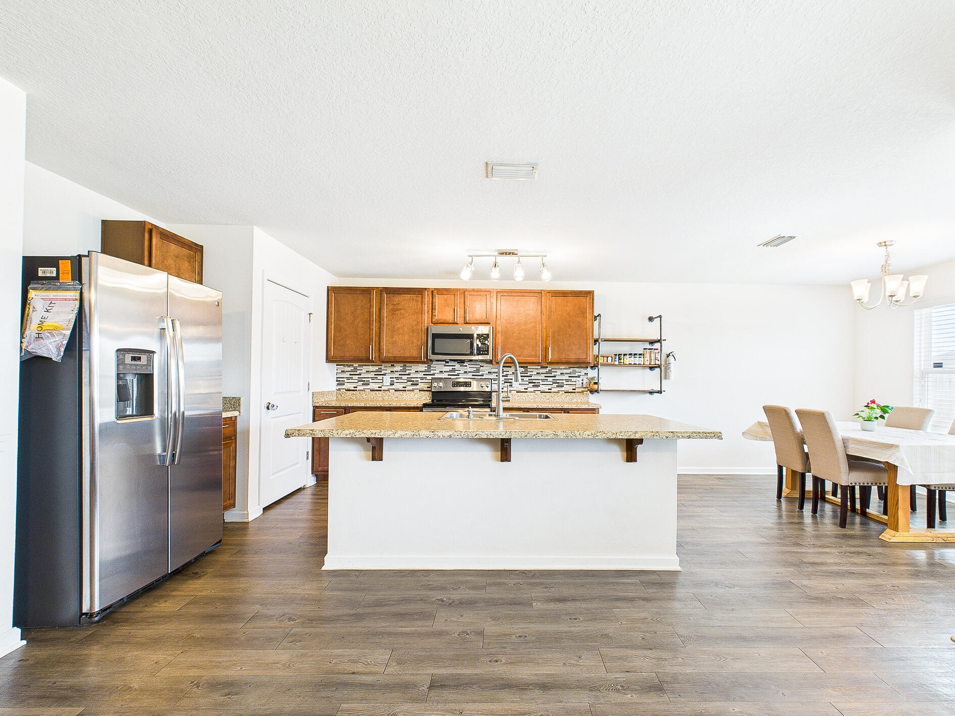 4611 Plover Drive Crestview, FL 32539 - Photo 6 of 27 a kitchen with stainless steel appliances kitchen island granite countertop a stove and white cabinets
