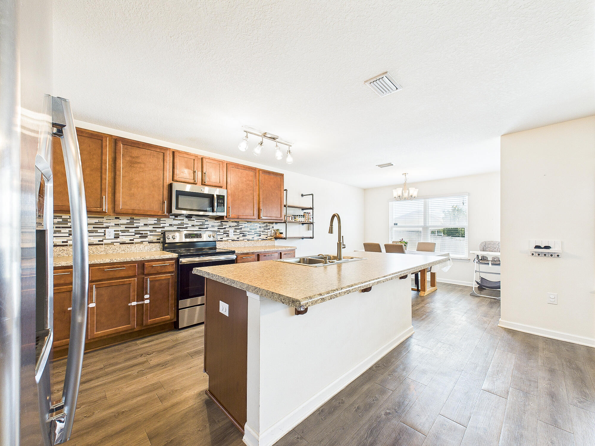 4611 Plover Drive Crestview, FL 32539 - Photo 7 of 27 a kitchen with a sink stove and refrigerator