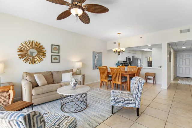 a living room with furniture a dining table and a flat screen tv