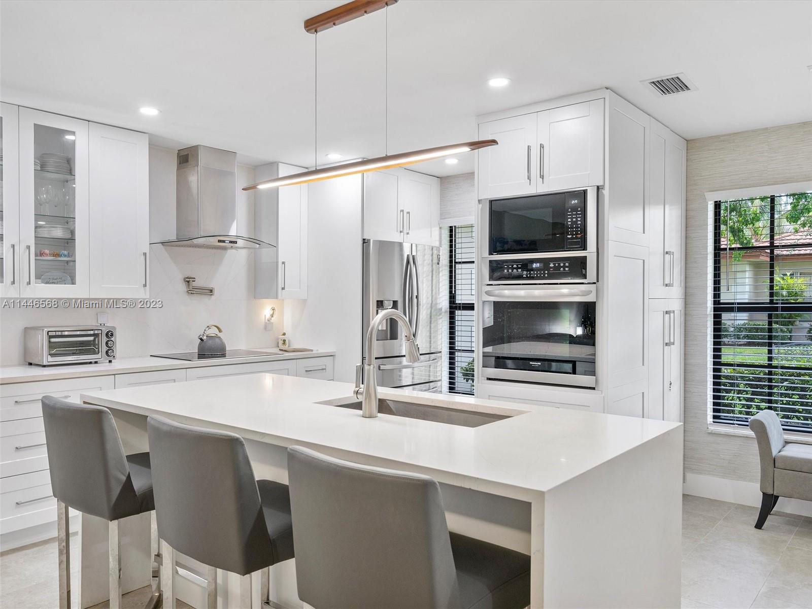 2358 Southwest 70th Way, Unit 6 Davie, FL 33317 - Photo 1 of 55 a kitchen with stainless steel appliances a sink stove refrigerator and cabinets