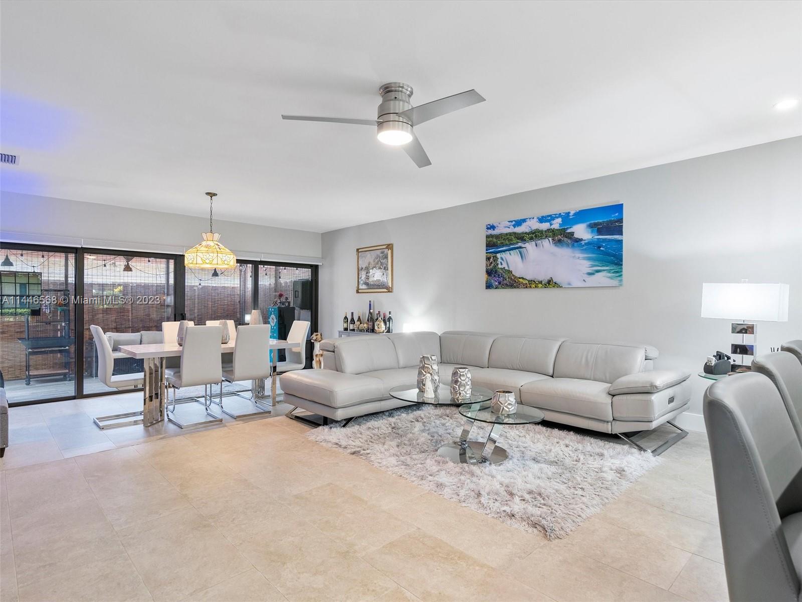 2358 Southwest 70th Way, Unit 6 Davie, FL 33317 - Photo 19 of 55 a living room with furniture and a chandelier