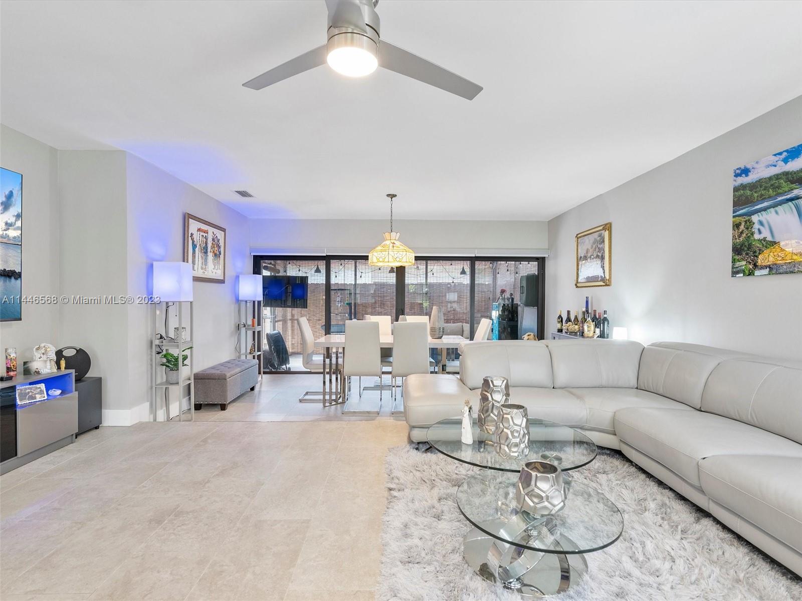 2358 Southwest 70th Way, Unit 6 Davie, FL 33317 - Photo 21 of 55 a living room with furniture and a chandelier