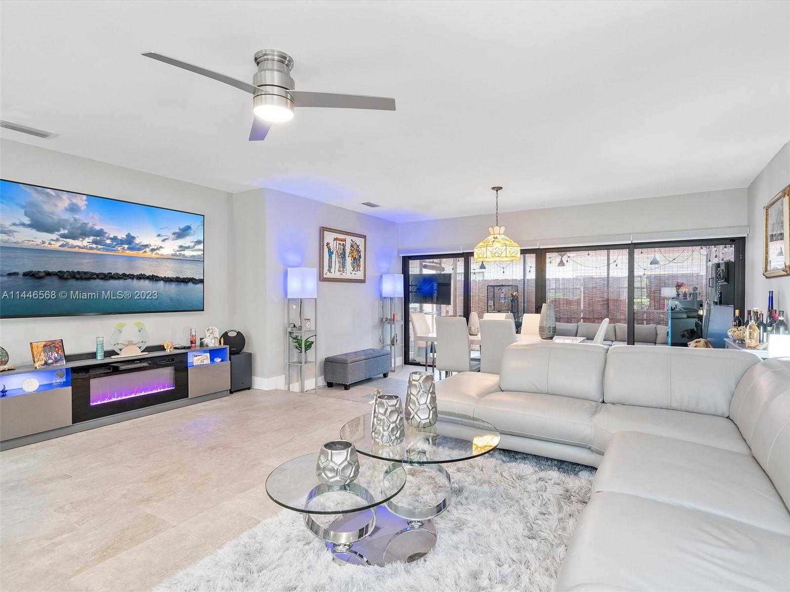 2358 Southwest 70th Way, Unit 6 Davie, FL 33317 - Photo 22 of 55 a living room with furniture and a chandelier