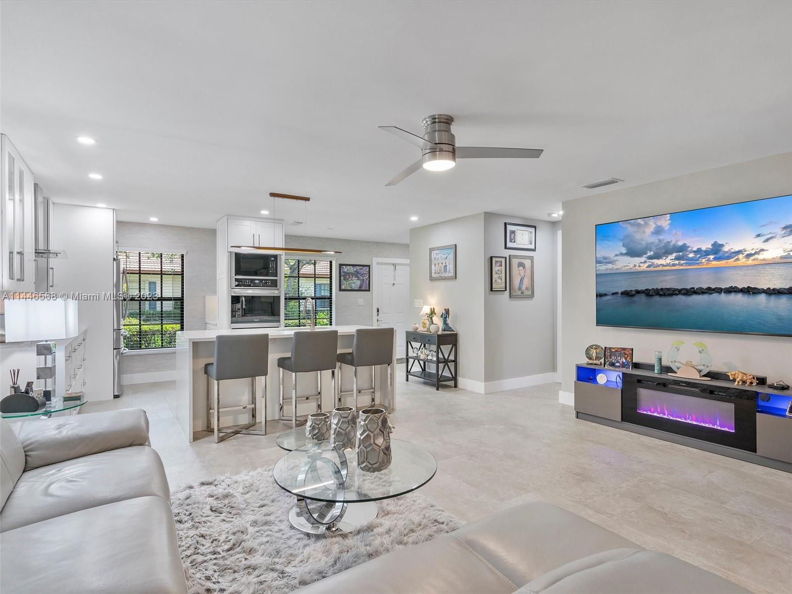 2358 Southwest 70th Way, Unit 6 Davie, FL 33317 - Photo 25 of 55 a living room with furniture and a flat screen tv