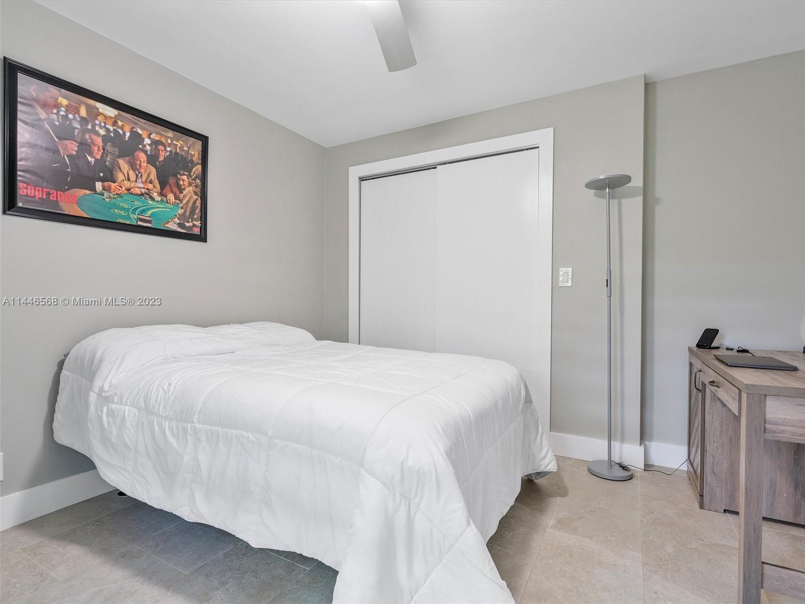 2358 Southwest 70th Way, Unit 6 Davie, FL 33317 - Photo 31 of 55 a bedroom with a bed and a chandelier