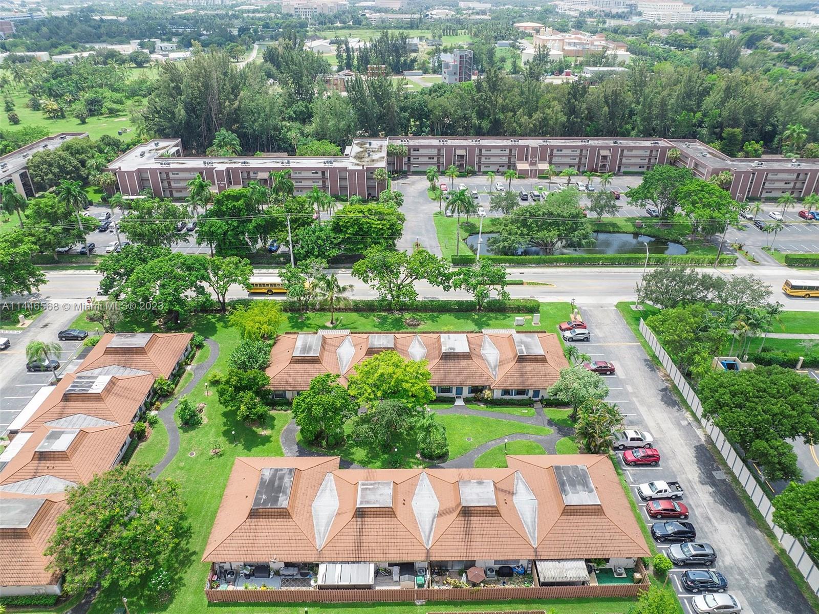 2358 Southwest 70th Way, Unit 6 Davie, FL 33317 - Photo 52 of 55 an aerial view of a house with a garden and lake view
