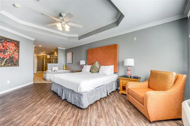 a spacious bedroom with a bed and lamp