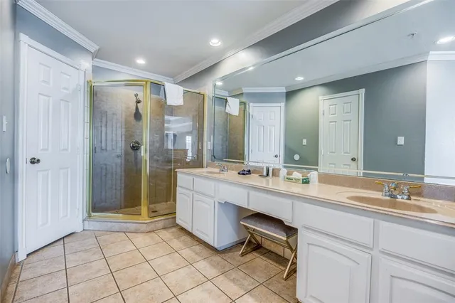 a bathroom with a double vanity sink mirror and shower