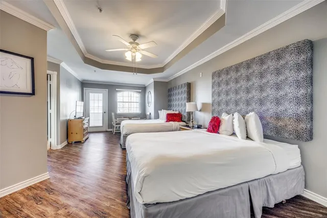 a bedroom with a large bed and a chandelier