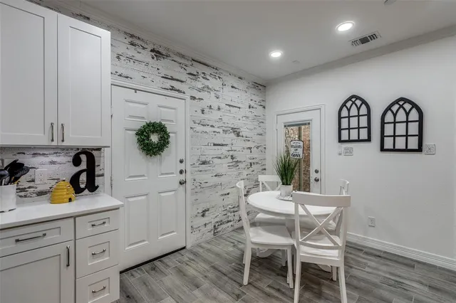 a view of a workspace with furniture and wooden floor