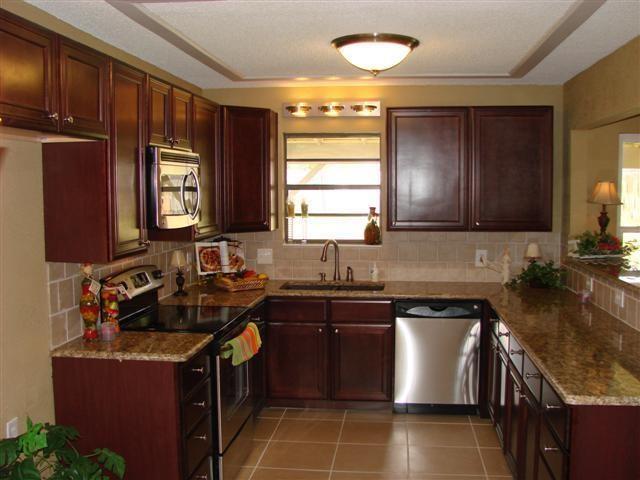 a kitchen with a sink stove top oven and cabinets