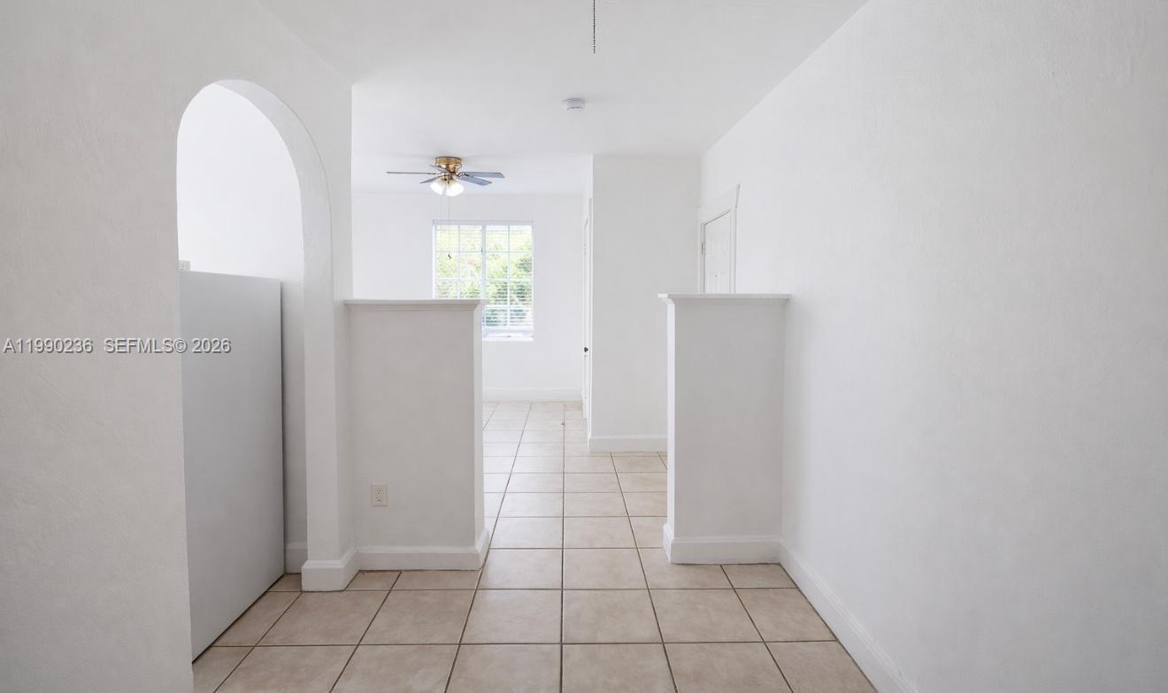 1563 Southwest 2nd Street, Unit 8 Miami, FL 33135 - Photo 3 of 10 an empty room with wooden floor and windows