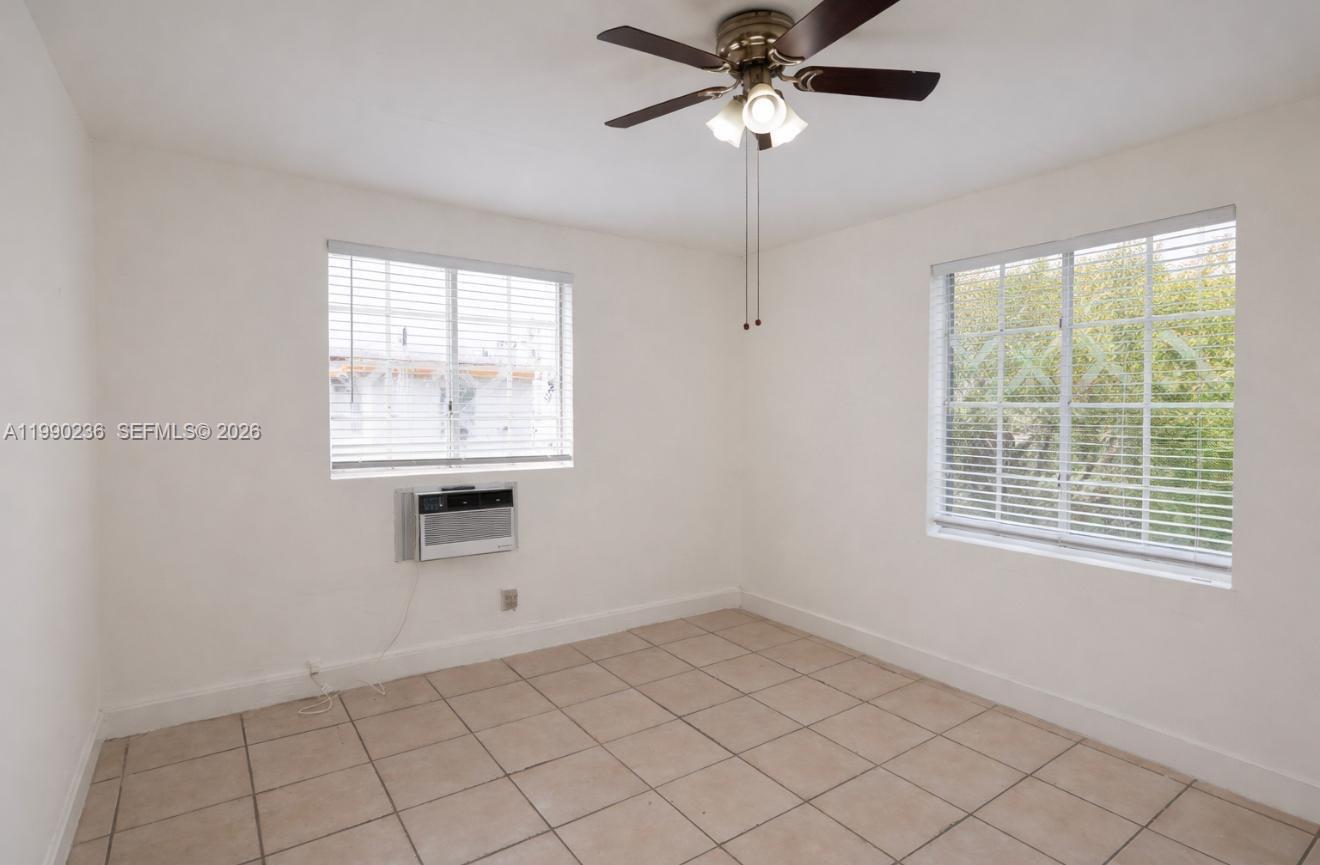 1563 Southwest 2nd Street, Unit 8 Miami, FL 33135 - Photo 4 of 10 an empty room with a window and a fan