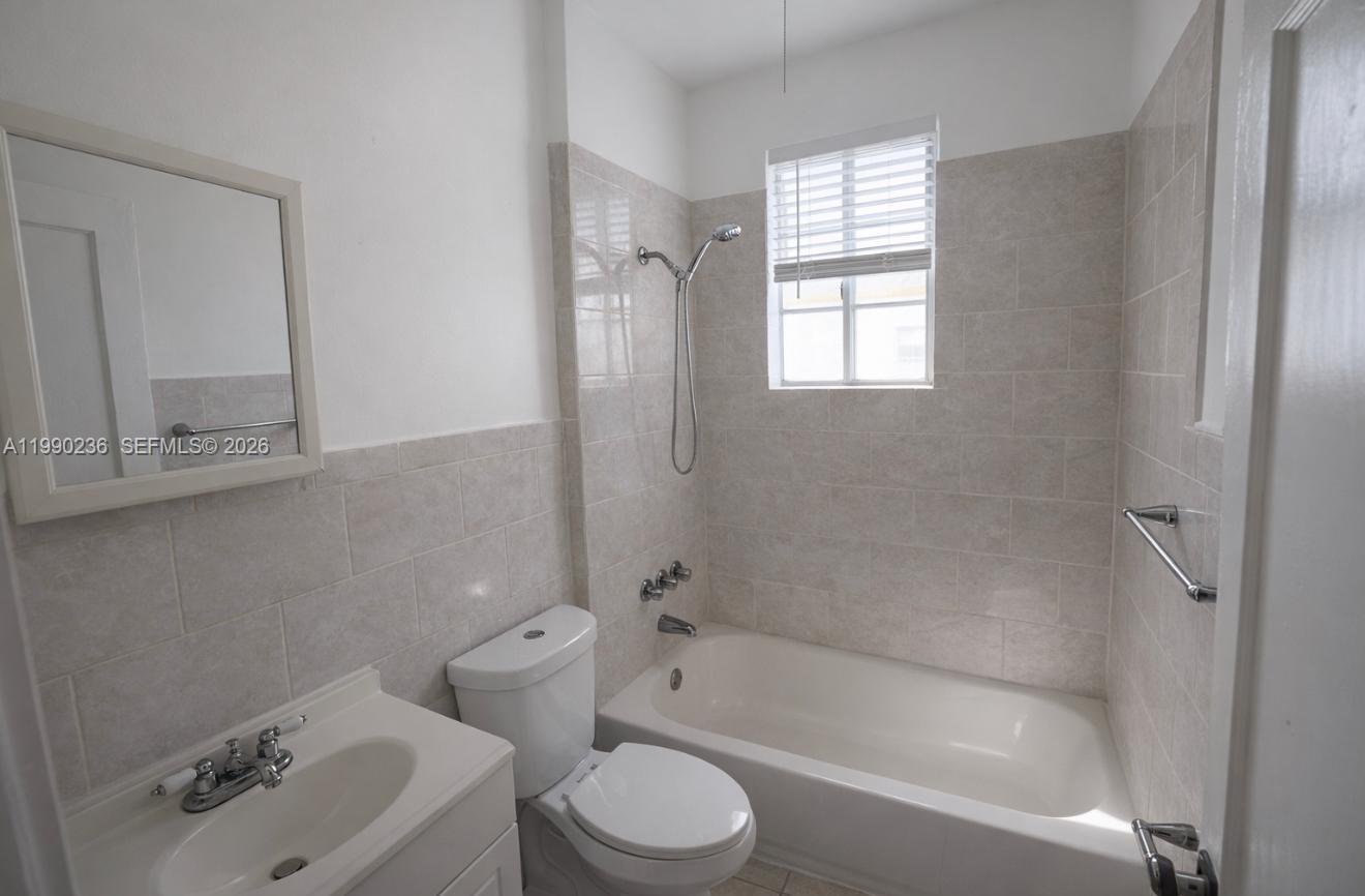 1563 Southwest 2nd Street, Unit 8 Miami, FL 33135 - Photo 7 of 10 a bath room with a toilet sink bath tub and shower