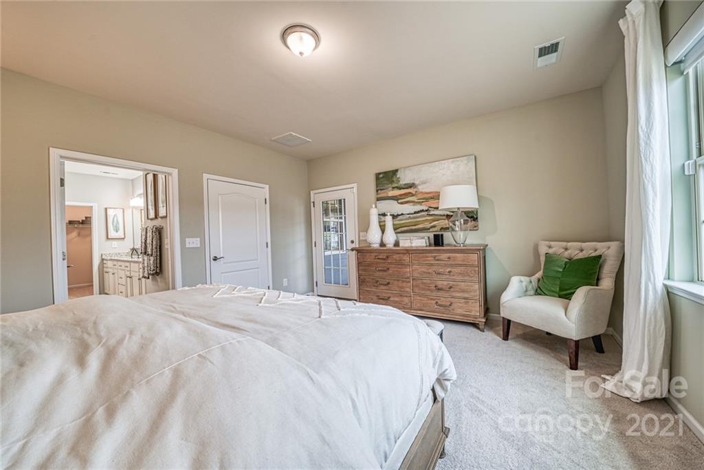 3138 Windhaven Lane, Unit 146 Tega Cay, SC 29708 - Photo 8 of 13 a bedroom with a bed and wooden floor