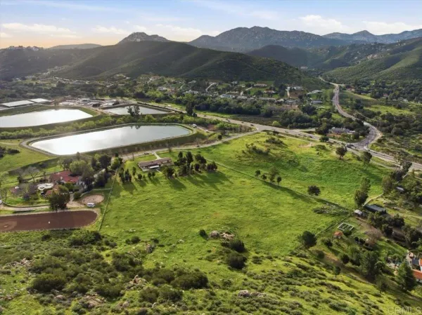 a view of a lush green hillside and houses