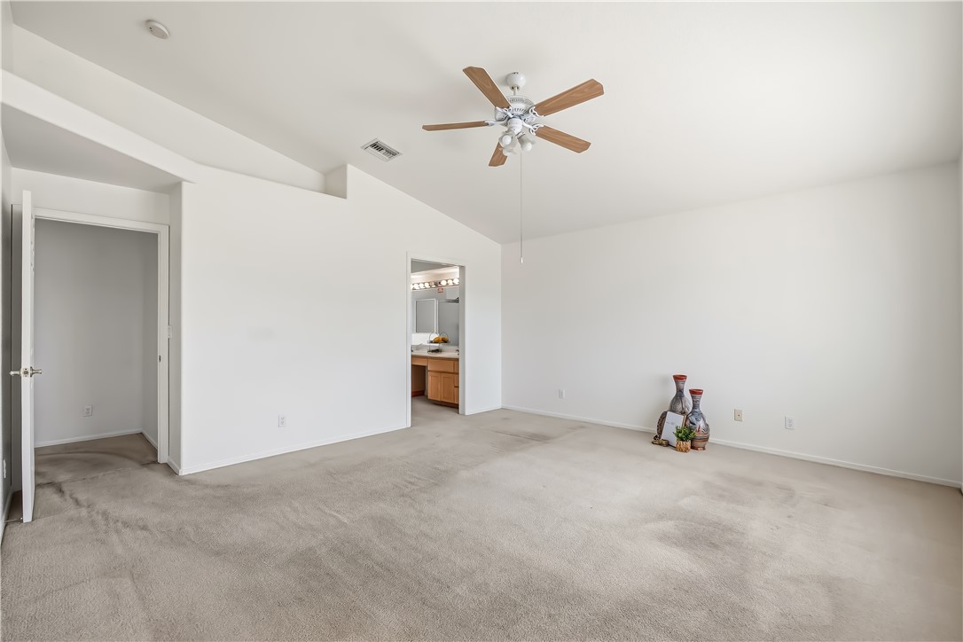 2853 Winchester Road Bullhead City, AZ 86442 - Photo 22 of 40 Spacious interior room featuring a vaulted ceiling and a ceiling fan with integrated lighting