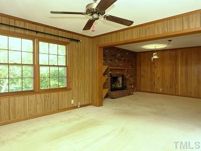 4611 Connell Drive Raleigh, NC 27612 - Photo 7 of 13 a view of an empty room with a fireplace and a window