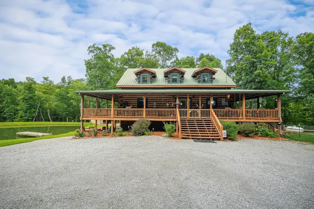 a view of a house with a yard and sitting area